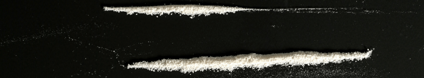 heroin mixed cocaine lined up on black background