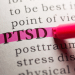 The acronym PTSD emboldened and highlighted in a book