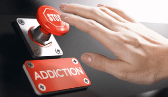 Hand pressing a red button that says "STOP ADDICTION"
