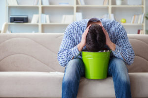 Man Puking Into Bucket