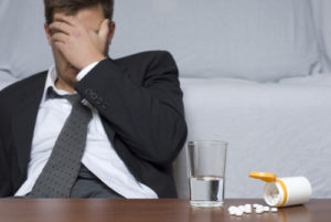 frustrated man in front of a spilled prescription