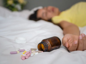 woman passed out overdosing on pills