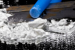 Cocaine, a razor, and a blue straw