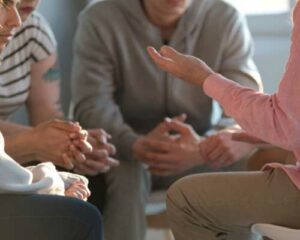 People sitting in a circle conversing