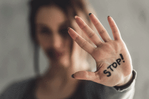Woman with "Stop" written on her hand