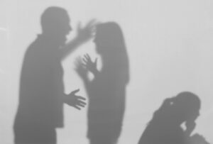 Silhouettes of a family having an argument.