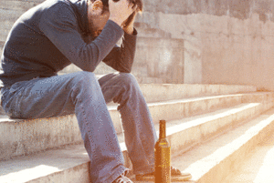 Stressed man with his hands on his head sitting on some steps