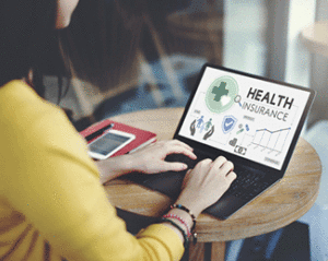 Woman reading a PowerPoint about insurance on her laptop.