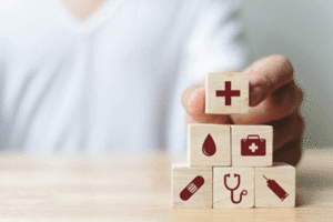 various medical symbols on a stack of wooden blocks