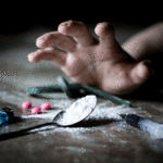 Hand grabbing for pills and white powder