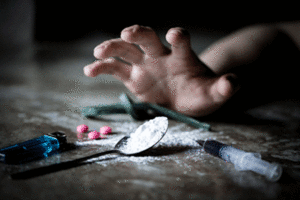 Hand grabbing for pills and white powder