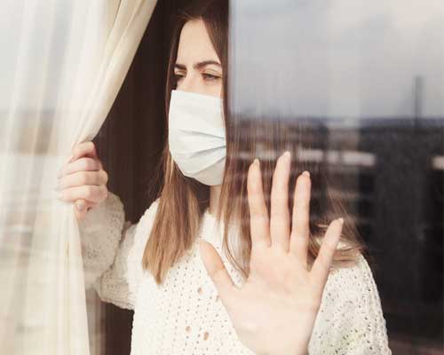 woman-in-quarantine-looks-out-window